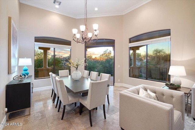 dining room with a healthy amount of sunlight, crown molding, and an inviting chandelier