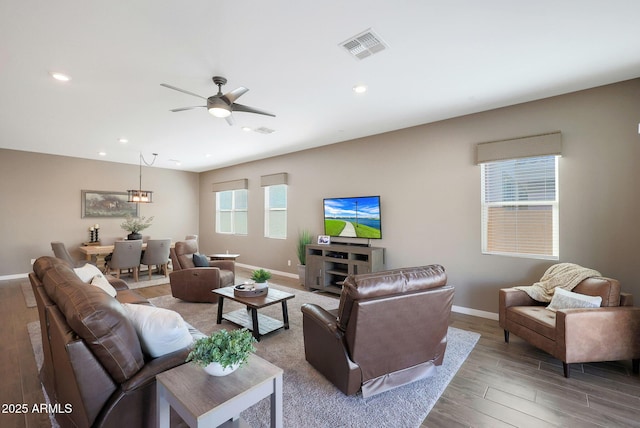 living room with ceiling fan and wood-type flooring