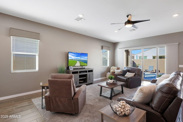 living room featuring ceiling fan and light hardwood / wood-style floors