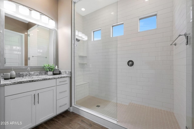 bathroom featuring vanity and a tile shower