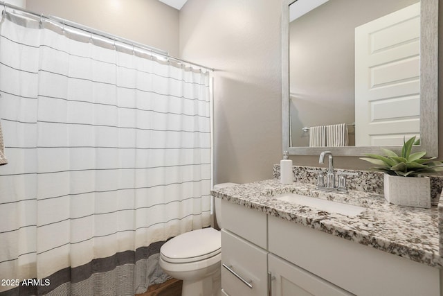 bathroom featuring vanity, a shower with curtain, and toilet