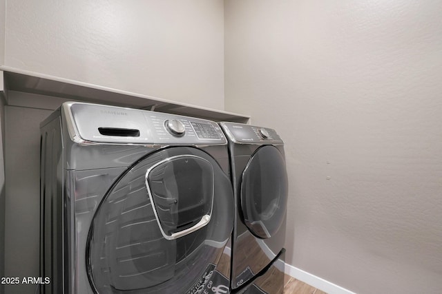 laundry room featuring light hardwood / wood-style flooring and independent washer and dryer