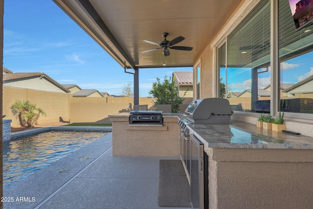 view of patio with ceiling fan, an outdoor kitchen, and grilling area