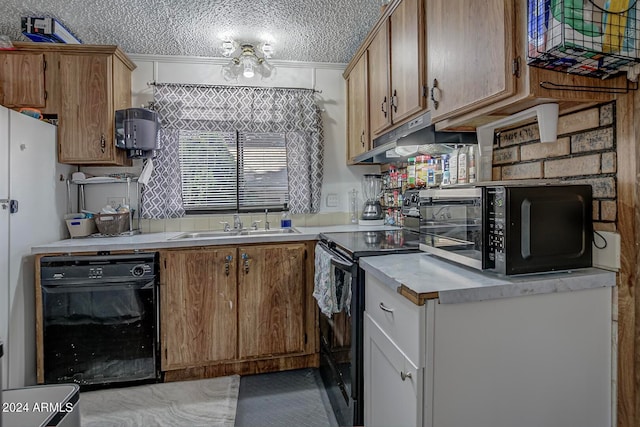 kitchen with black appliances and a textured ceiling