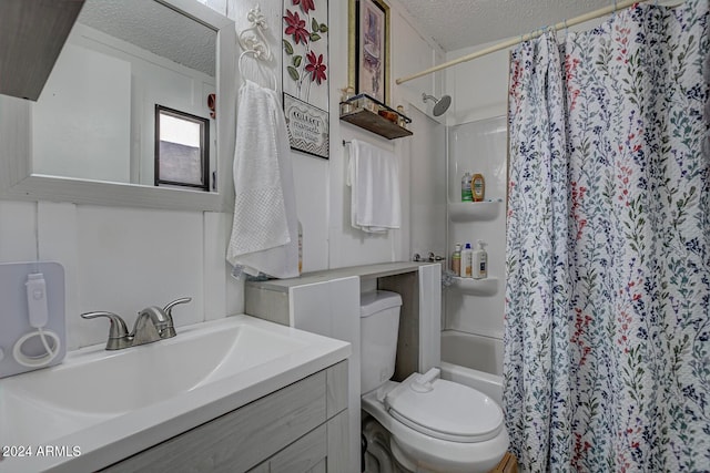 full bathroom with vanity, shower / bath combination with curtain, toilet, and a textured ceiling