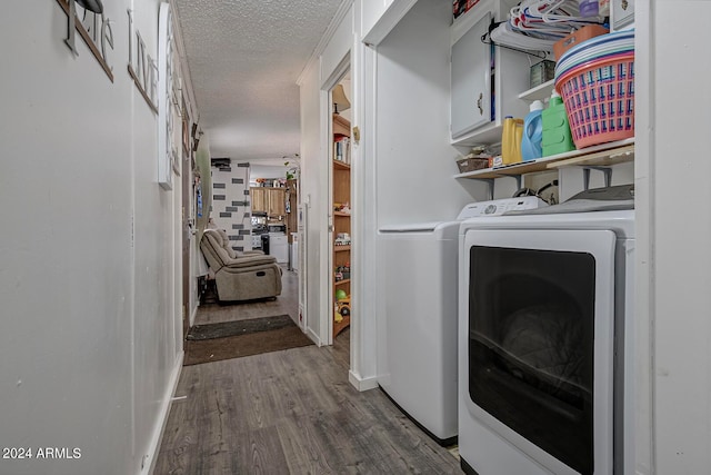 clothes washing area with a textured ceiling, wood-type flooring, and washing machine and clothes dryer