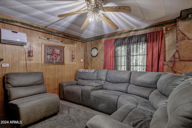 carpeted living room featuring wood walls, ceiling fan, and a wall mounted AC