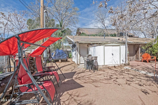 exterior space featuring a storage unit and grilling area