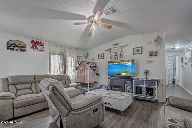 living room featuring ceiling fan, a textured ceiling, dark hardwood / wood-style flooring, and vaulted ceiling