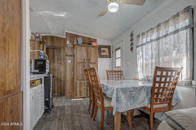 dining space featuring ceiling fan, dark hardwood / wood-style floors, a textured ceiling, and lofted ceiling