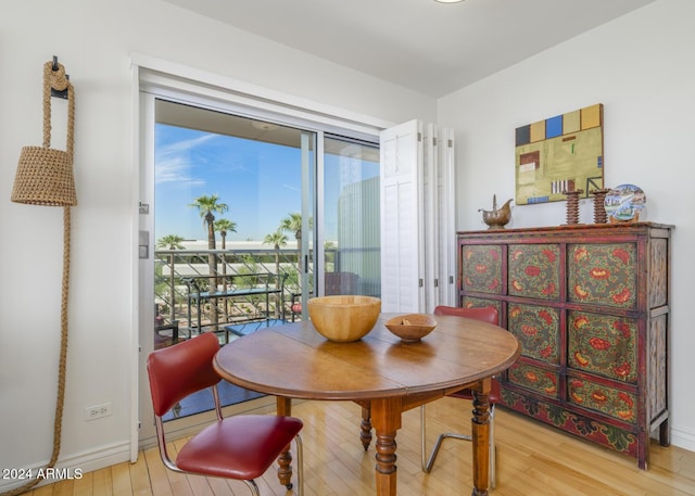 2201 N Central Ave Unit 4E, Phoenix, AZ 85004 - dining area with wood finished floors and baseboards