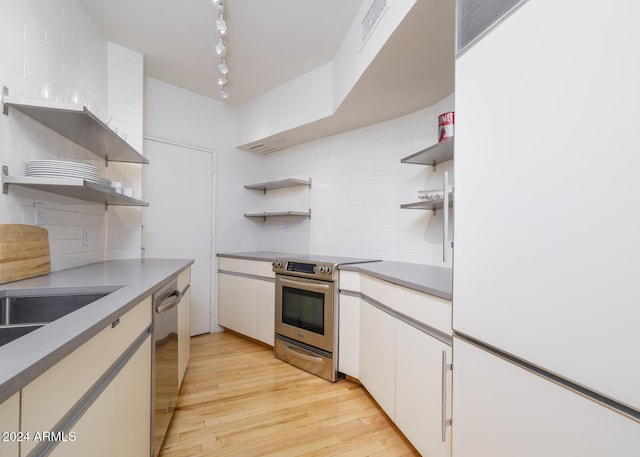 2201 N Central Ave Unit 4E, Phoenix, AZ 85004 - kitchen featuring open shelves, appliances with stainless steel finishes, and tasteful backsplash
