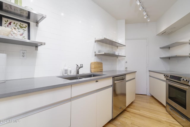 2201 N Central Ave Unit 4E, Phoenix, AZ 85004 - kitchen with open shelves, appliances with stainless steel finishes, a sink, and backsplash
