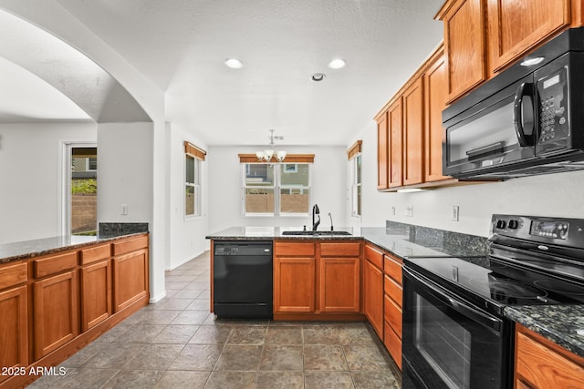 2337 E Fraktur Rd, Phoenix, AZ 85040 - kitchen featuring brown cabinetry, a sink, a peninsula, and black appliances