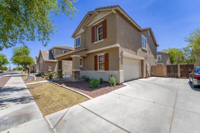 2337 E Fraktur Rd, Phoenix, AZ 85040 - traditional-style house featuring an attached garage, fence, driveway, and stucco siding