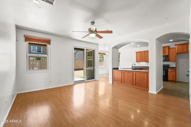2337 E Fraktur Rd, Phoenix, AZ 85040 - unfurnished living room with ceiling fan, a wealth of natural light, and light wood-style flooring