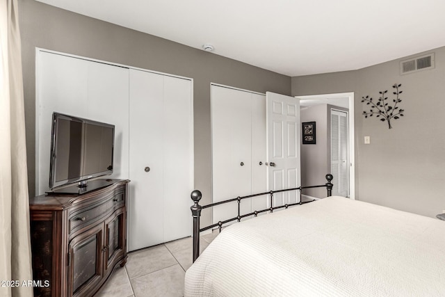 7436 E Chaparral Rd Unit 124B, Scottsdale, AZ 85250 - bedroom featuring multiple closets and light tile patterned floors