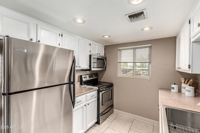 7436 E Chaparral Rd Unit 124B, Scottsdale, AZ 85250 - kitchen with stainless steel appliances, a sink, light countertops, white cabinets, and recessed lighting