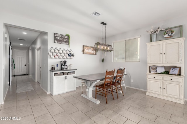 dining area with visible vents, baseboards, and light tile patterned floors