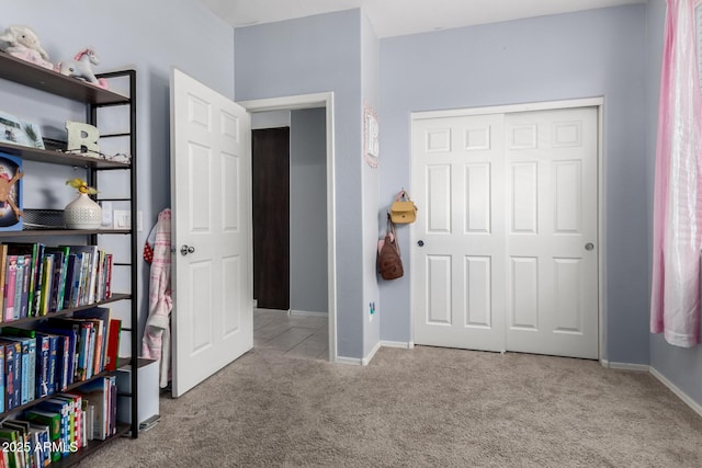 bedroom featuring carpet floors, a closet, and baseboards