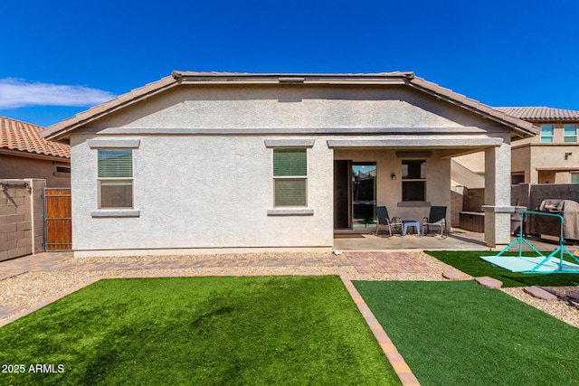 back of house with a patio area, fence, and stucco siding