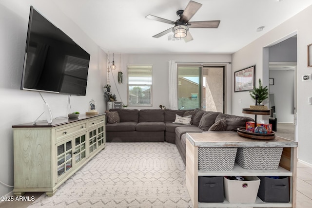 living area with ceiling fan