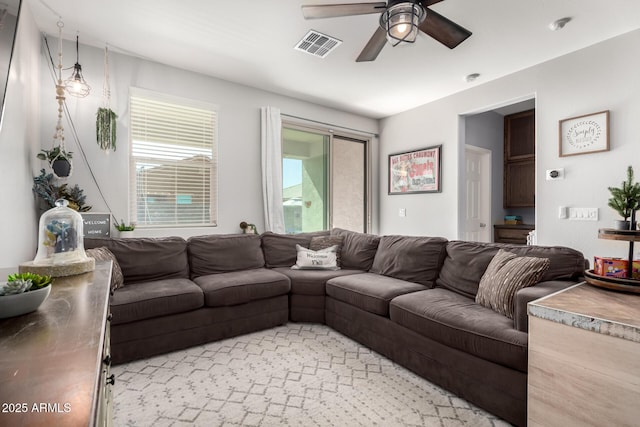 living room featuring visible vents and ceiling fan