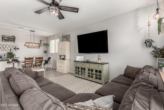 living area featuring visible vents, ceiling fan, and tile patterned floors