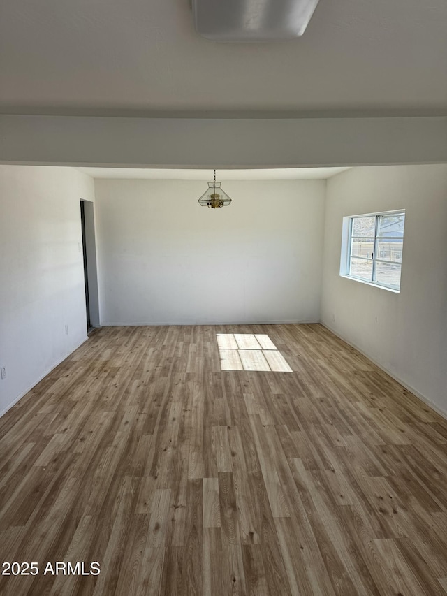 unfurnished room with wood-type flooring