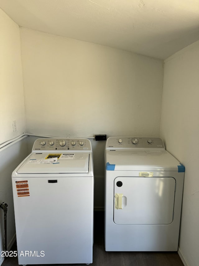 clothes washing area featuring washer and clothes dryer