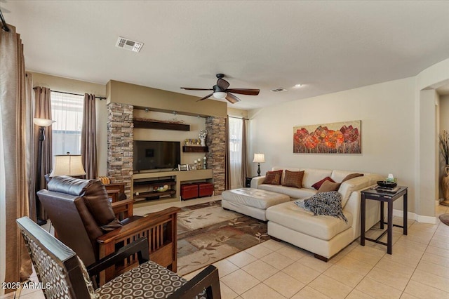 living area with a ceiling fan, visible vents, baseboards, and light tile patterned floors