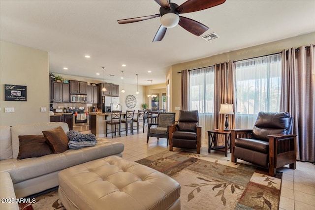 living room with recessed lighting, ceiling fan, visible vents, and light tile patterned flooring