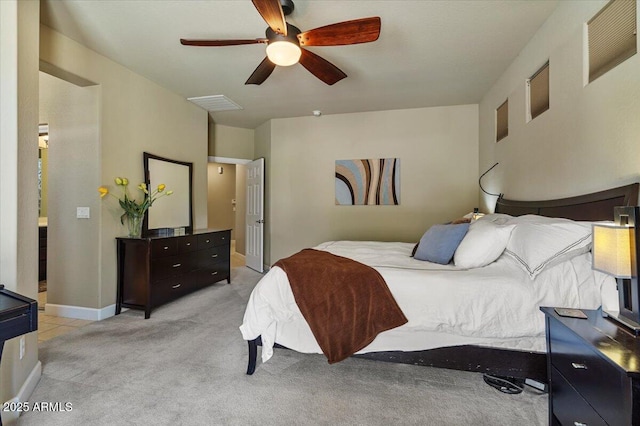 bedroom with baseboards, ceiling fan, visible vents, and light colored carpet