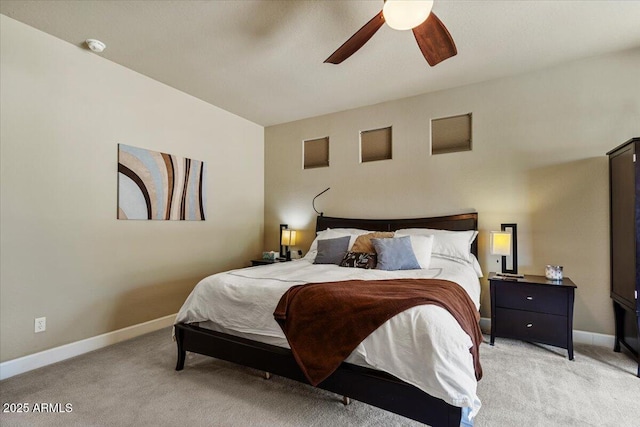 bedroom featuring light carpet, ceiling fan, and baseboards