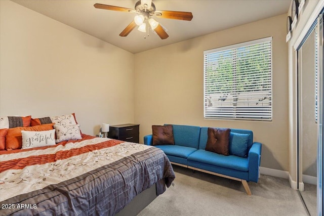 bedroom featuring a closet, light colored carpet, ceiling fan, and baseboards