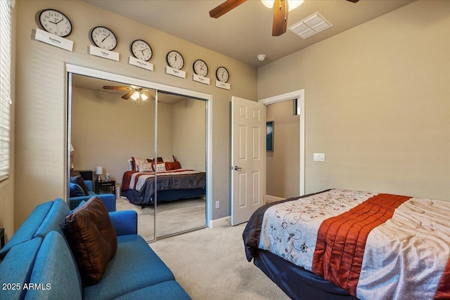 bedroom featuring a closet, visible vents, ceiling fan, and light carpet
