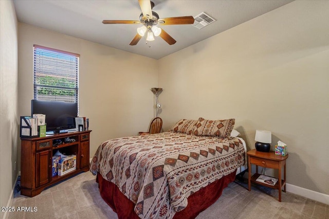 bedroom featuring baseboards, visible vents, a ceiling fan, and light colored carpet