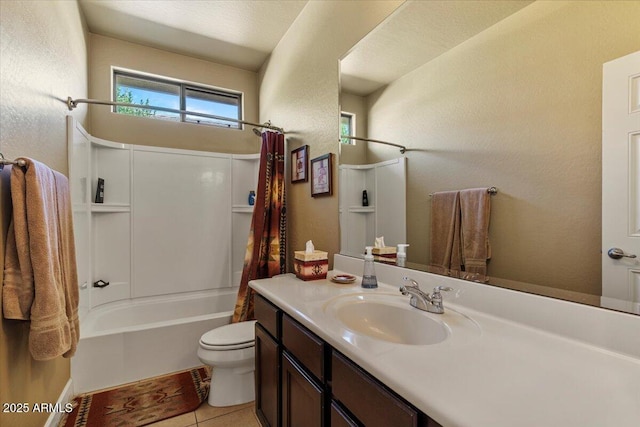full bath with a textured wall, toilet, tile patterned flooring, shower / bath combo with shower curtain, and vanity