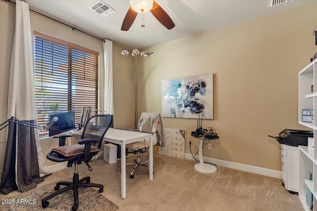 office area featuring baseboards, visible vents, ceiling fan, and light colored carpet