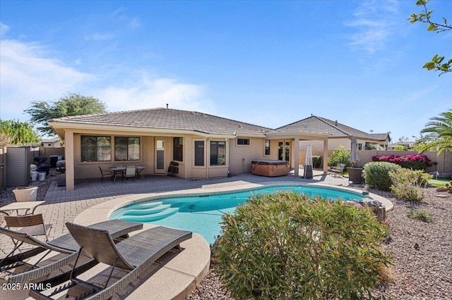 view of swimming pool with a fenced in pool, a patio area, fence, and a hot tub