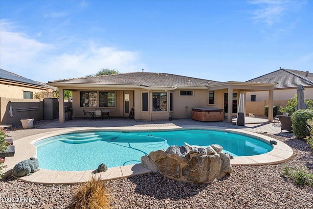 view of pool featuring a fenced in pool, a fenced backyard, a patio, and a hot tub