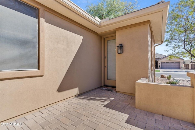 doorway to property featuring stucco siding