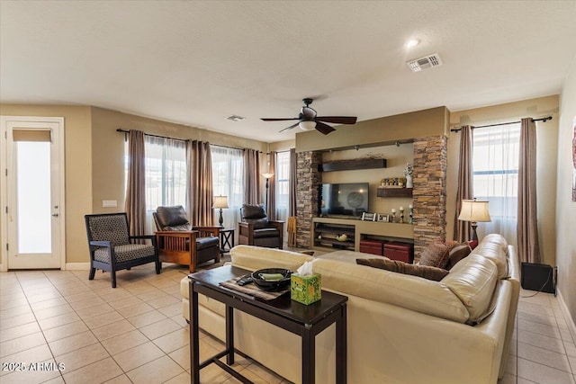 living area featuring visible vents, plenty of natural light, and light tile patterned floors