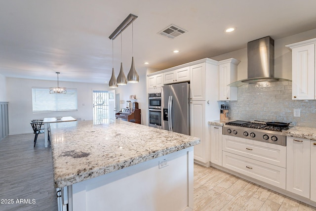 kitchen with stainless steel appliances, visible vents, white cabinets, backsplash, and wall chimney exhaust hood