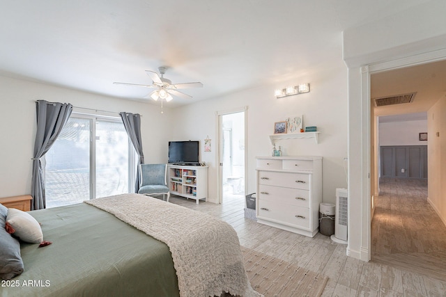 bedroom with light wood-style flooring, visible vents, and a ceiling fan