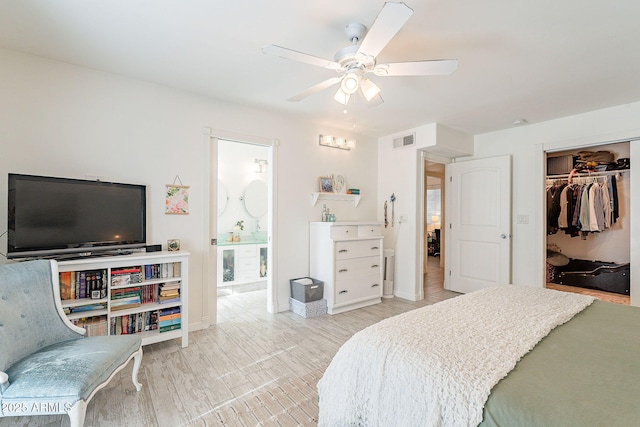 bedroom featuring baseboards, visible vents, ceiling fan, ensuite bathroom, and a closet