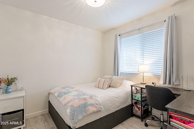 bedroom featuring baseboards and light wood-style floors