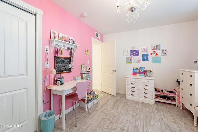 interior space featuring visible vents, baseboards, light wood-style flooring, and an inviting chandelier