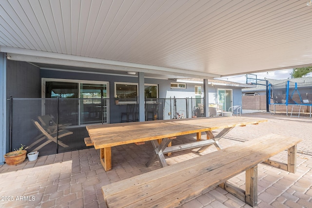 view of patio / terrace with a trampoline and outdoor dining space