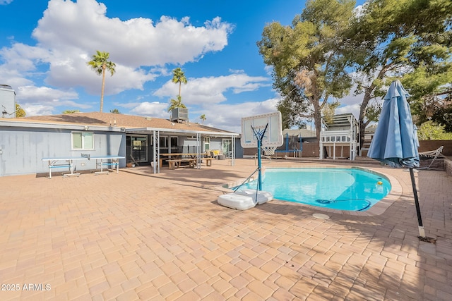 pool with a patio and central AC